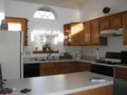 Sunny kitchen full of amenities.